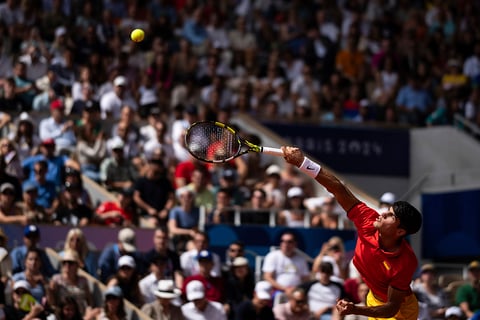  Carlos Alcaraz serves to Serbia's Novak Djokovic